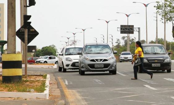 
A woman rushes across a busy road in Brazil. Approximately 1.3 million people die annually as a result of road traffic accidents around the world.