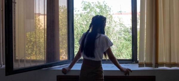 A 14-year-old girl looks out the window, in Kyzylorda, Kazakhstan. Recently, she has addressed feelings of stress and anxiety with the help of an educational psychologist.
