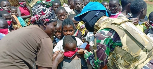 
A peacekeeper from MONUSCO’s Female Engagement Team distributes facemasks at a village in Walungu in the Democratic Republic of the Congo. — courtesy MONUSCO