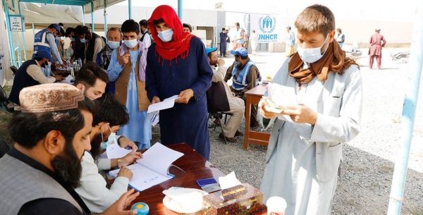 Displaced people receive aid at a distribution site in Kabul, Afghanistan. — courtesy UNHCR/Tony Aseh