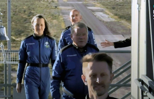 The Blue Origin rocket, with actor William Shatner onboard, lifts off from the launch pad.