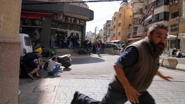 A man runs to take cover during armed clashes on the streets of Beirut on Thursday.