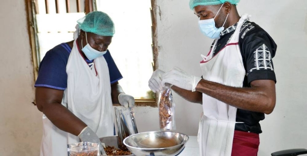 Anastasie Obama (left) packages smoked prawns for sale. — courtesy T.Graphics