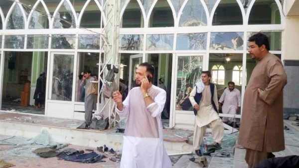 People view the carnage after a suicide attack at the largest Shiite mosque in the southern Afghan city of Kandahar. — courtesy BBC