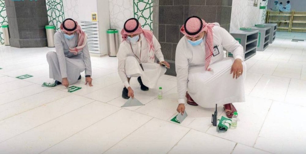 Workers have begun removing social distancing stickers from indoor and outdoor corridors, squares and facilities of the Grand Mosque.