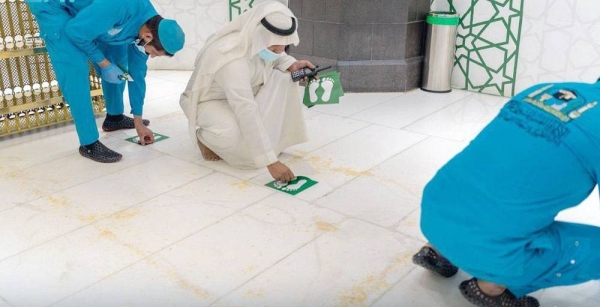 Workers have begun removing social distancing stickers from indoor and outdoor corridors, squares and facilities of the Grand Mosque.