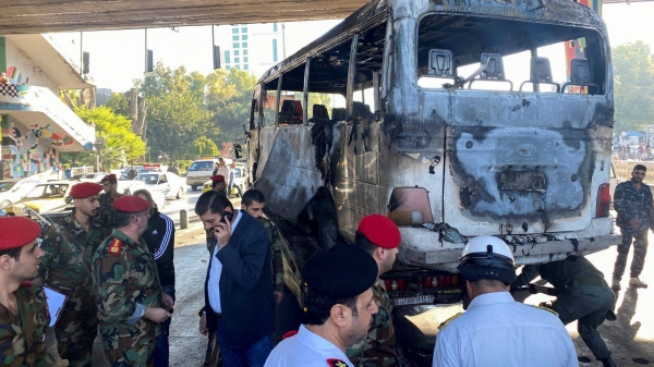 The bus was hit as it passed under a bridge in central Damascus.