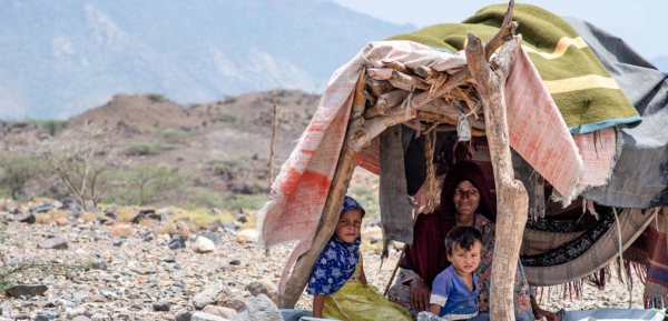 A displaced woman and her children in a makeshift shelter on the west coast of Yemen.