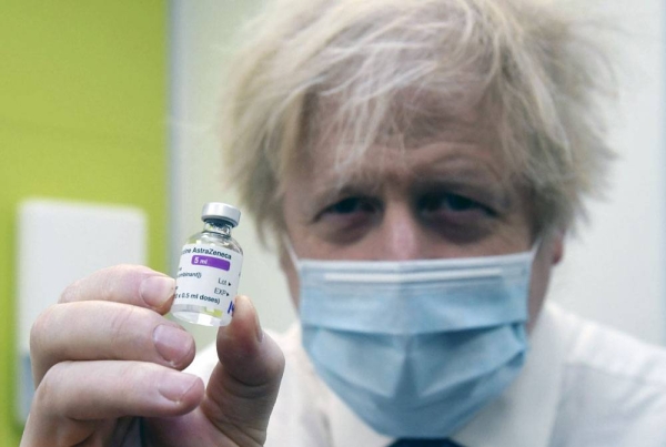 File photo shows British Prime Minister Boris Johnson showing off the AstraZeneca vaccine.