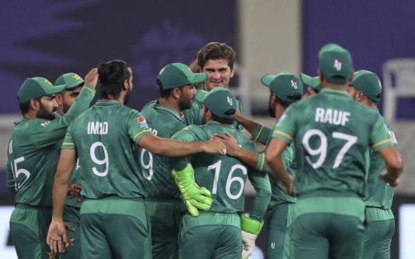 Pakistan's cricketers congratulate teammate Shaheen Afridi for the dismissal of India's KL Rahul during the Cricket Twenty20 World Cup match.