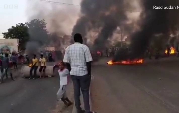 Chanting and waving flags, protesters have blocked roads in Sudan's capital Khartoum and other cities following the coup.