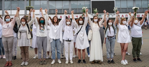 Women protesters hold hands in solidarity over the disputed presidential election in Belarus.