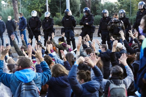 Climate activists encounter a wall of police as they demonstrate in Rome, Saturday, the day the Group of 20 summit started in the Italian capital.