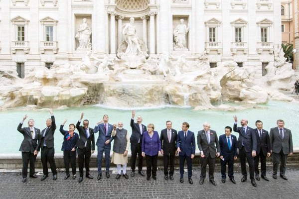 Leaders of the G20 throw coins inside the Trevi Fountain during an event for the G20 summit in Rome, Sunday.