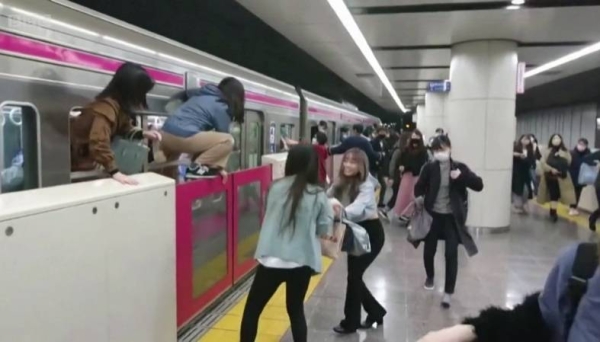 A video grab from the incident shows people jumping out of the train as it fills with smoke.