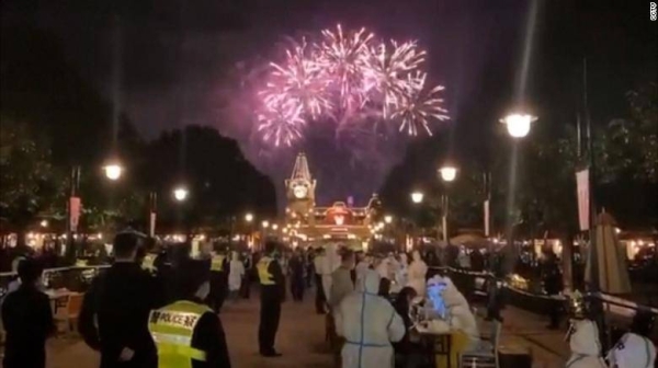 Fireworks light up the night sky at Shanghai Disneyland on Sunday as visitors line up for mandatory Covid-19 tests.
