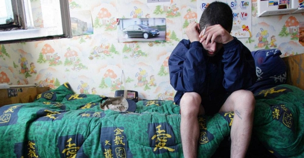 A 19 year-old boy sits on his bed at a shelter for children who live or work on the streets, in Odessa, Ukraine. He is a drug user and HIV-positive, but does not have access to antiretroviral medications. — courtesy UNICEF/Giacomo Pirozzi