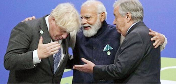 Indian Prime Minister Narendra Modi, center, shares a light moment with British Premier Boris Johnson, left, and UN Secretary-General Antonio Guterres at the COP26 Summit in Glasgow on Monday.