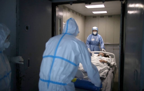 Medical workers tend to a patient in the emergency room at Moscow City Clinical Hospital (Filatov Hospital) where COVID-19 patients receive treatment. Russia's coronavirus cases rose by 39,008 in the past 24 hours.