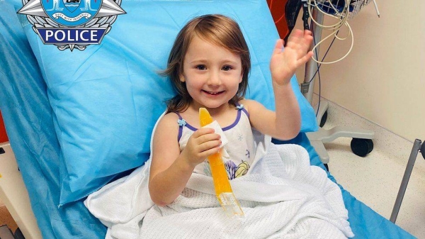 Cleo Smith waves from a hospital bed after her rescue.