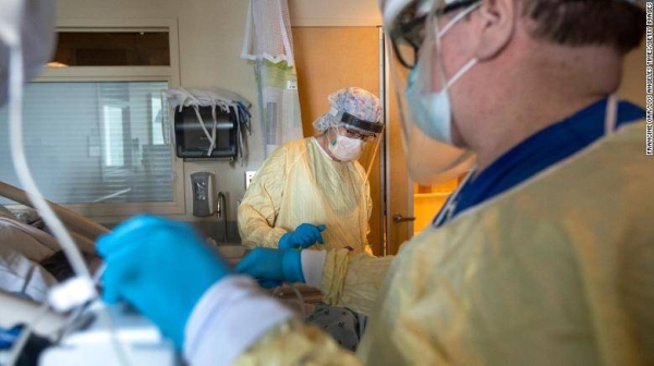 Health care workers assist a patient in the ICU inside Little Company of Mary Medical Center in Torrance, California.
