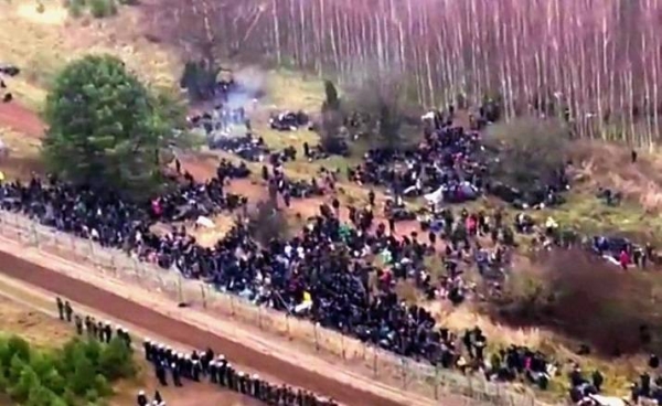 Video footage showed hundreds of people near a barbed-wire border fence, which some tried to force their way through.
