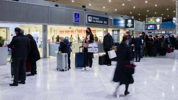 Passengers wait for processing at Charles de Gaulle airport in Paris, France, on Monday.
