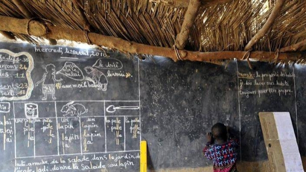 Many schools in Niger use straw-hut classrooms.