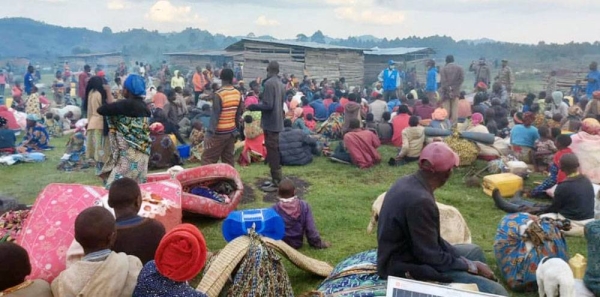 
A group of Congolese asylum-seekers wait at the Bunagana border point after crossing into Uganda from the Democratic Republic of the Congo. — courtesy UNHCR