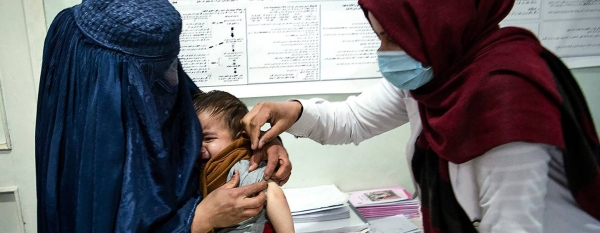 A health worker cares for a young boy in Parwan Province, Afghanistan in November 2020.
