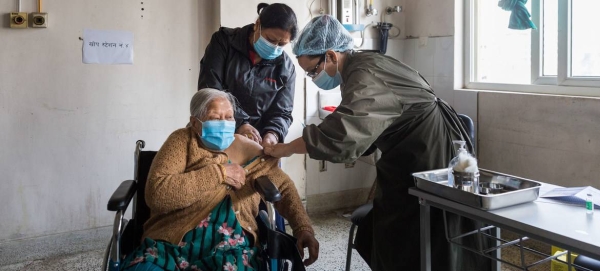 An elderly woman receives her COVID-19 vaccination at a hospital in Kathmandu, Nepal.