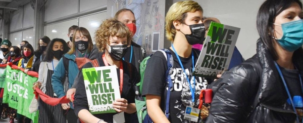 Civil organizations march inside the venue at the COP26 Climate Conference in Glasgow, Scotland, in a demonstration on the last day. — courtesy UN News/Laura Quiñones