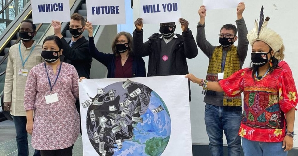 Civil organizations march inside the venue at the COP26 Climate Conference in Glasgow, Scotland, in a demonstration on the last day. — courtesy UN News/Laura Quiñones