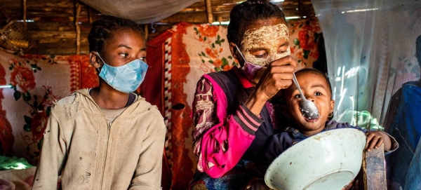 A mother feeds her child at home in Tshombe District, Madagascar, where nearly 55 per cent of the population is facing severe food insecurity.