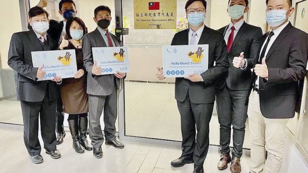 Eric Huang, newly appointed director to the representative office, third from right, poses with other staffers outside the Taiwan Representative Office in Vilinius, Lithuania. — courtesy AP/Taiwan Ministry of Foreign Affairs