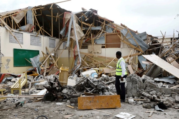 Security forces and rescue workers search for bodies at the scene of a blast in Mogadishu, Somalia Thursday.