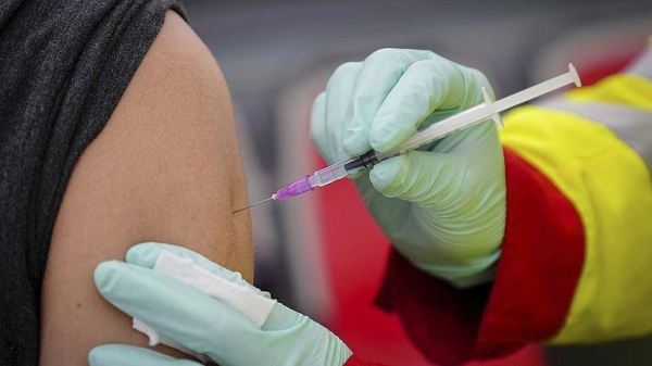 A person is vaccinated against the coronavirus at a vaccination bus in Berlin, Germany.