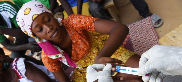 In Ndjamena, Chad, a seventeen-year-old girl smiles when she learns she's HIV negative.