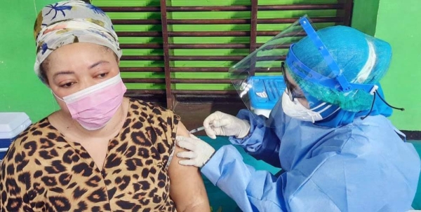 A refugee woman getting her first shot of the Sinopharm COVID-19 vaccine. — courtesy UNHCR Indonesia