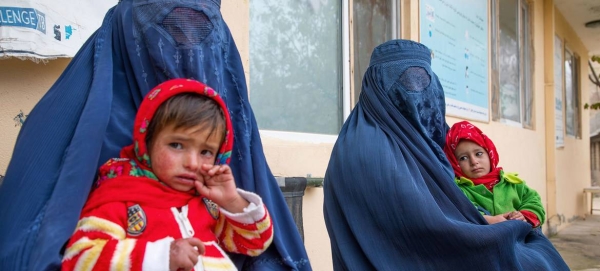 Women wait for their children to be screened for malnutrition at a clinic in Balkh Province, Afghanistan.