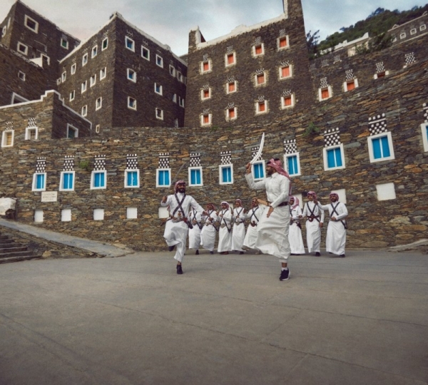 Men in Rijal Almaa traditionally dress in “futa” attire - a wraparound skirt with vibrant stripes. They are nicknamed ‘Flower Men’ as they adorn themselves with floral wreaths, a distinctive but lesser-known Saudi tradition.  (Supplied: Ministry of Tourism)