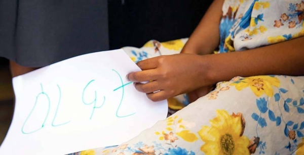 A woman holds a message which says 