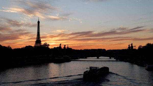The sunset on The Eiffel Tower and the River Seine, in Paris.