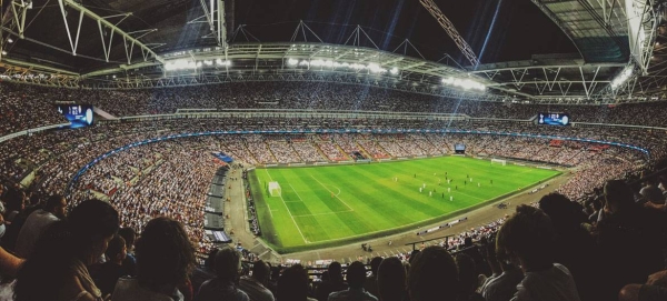 A crowd watching a football game inside Wembley Stadium in England in September 2016.