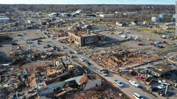 Bogdan Gaicki sits among debris on Sunday, December 12, in the Kentucky town of Mayfield after extreme weather hit the region.