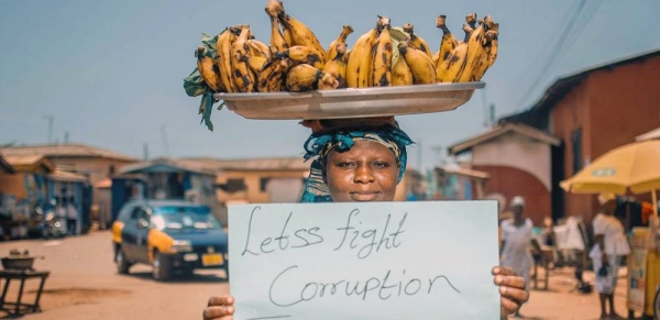 A female fruit vendor demonstrates against corruption in Ghana. — courtesy Unsplash/Nathaniel Tetteh