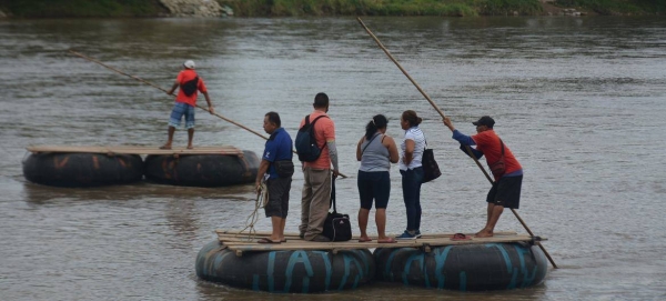 People cross the Suchiate River between Guatemala and Mexico.