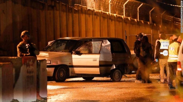 Israeli security forces inspect a car that came under gunfire near a settlement in the West Bank on December 16, 2021.