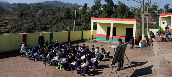Children attend class in open at a government middle school, Rajouri district, Jammu and Kashmir, India (file photo).
