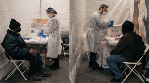 Medical workers prepare tests at a new testing site inside the Times Square subway station in New York City.